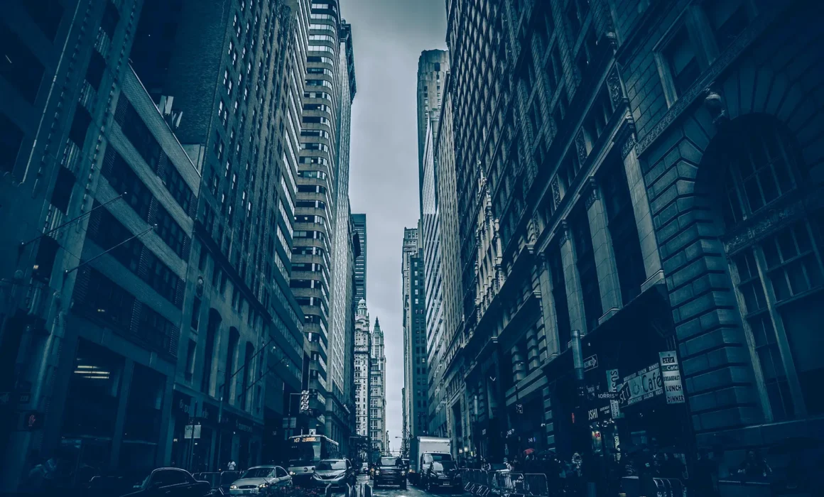 Rain-soaked city street amid towering skyscrapers