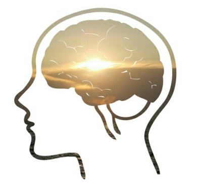 Silhouette of a head with a glowing brain and sunrise inside.