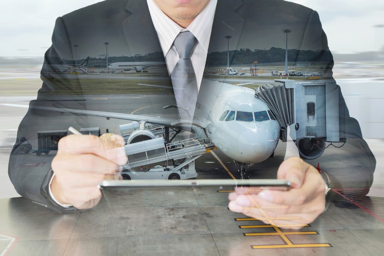 Businessman interacting with a tablet and airplane imagery. Businessman interacting with a tablet and airplane imagery.